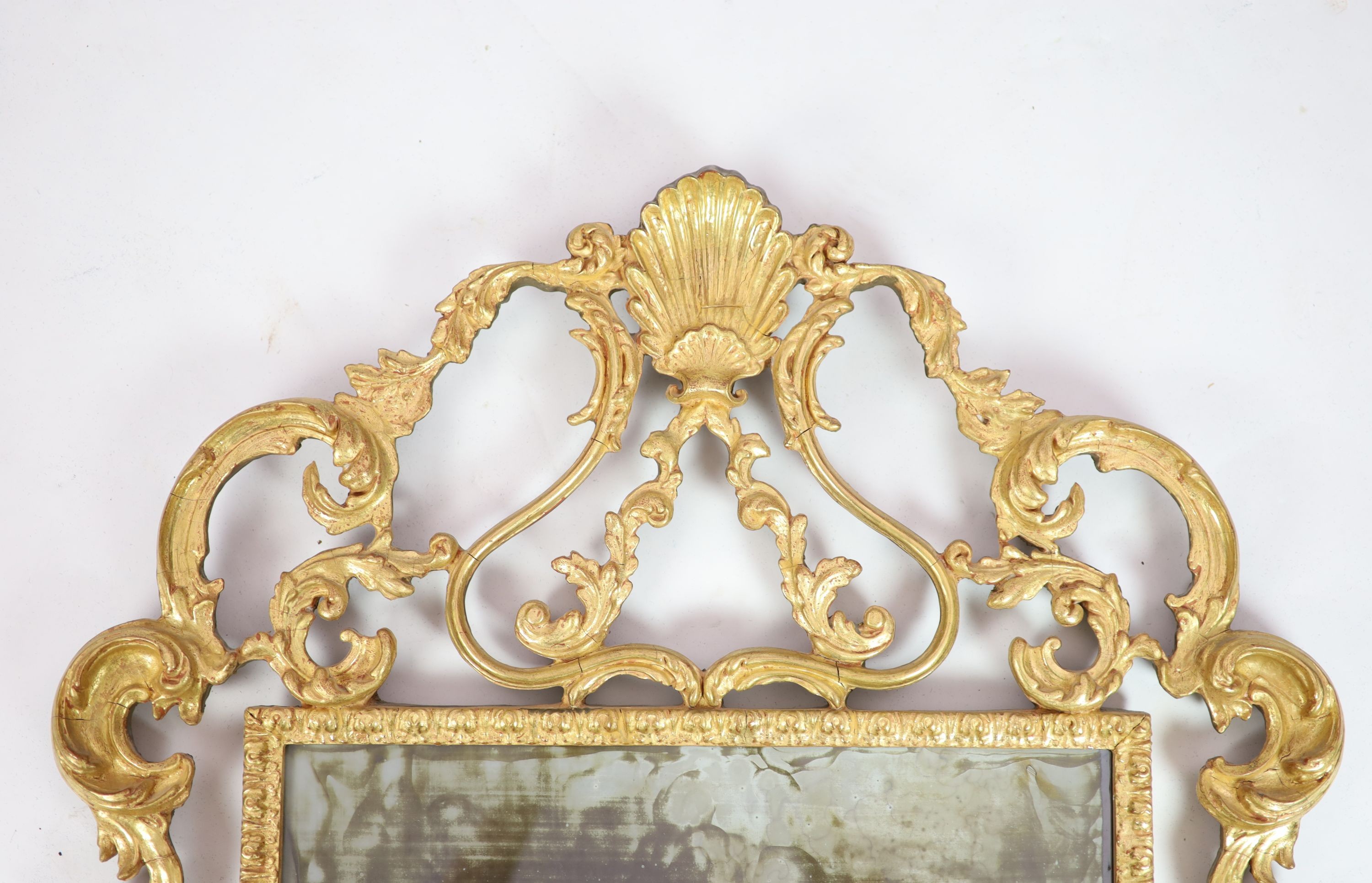 A George III style carved giltwood wall mirror, W.76cm H.110cm